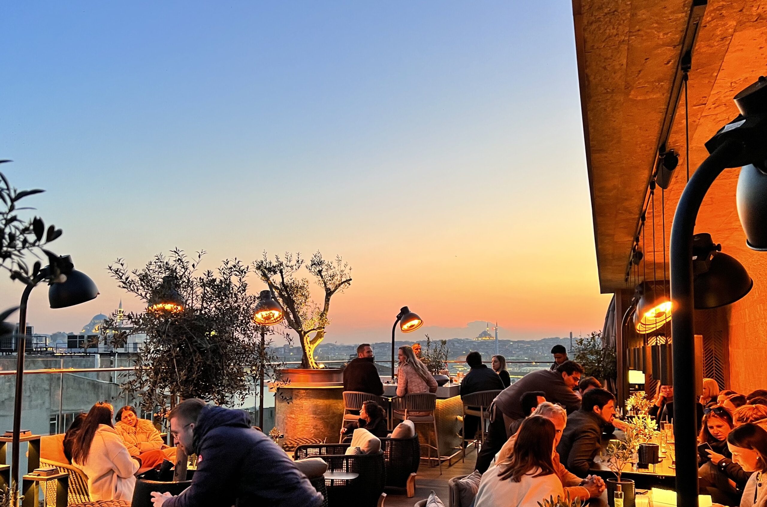 The Bank Roof Bar at sunset with the old city skyline behind it