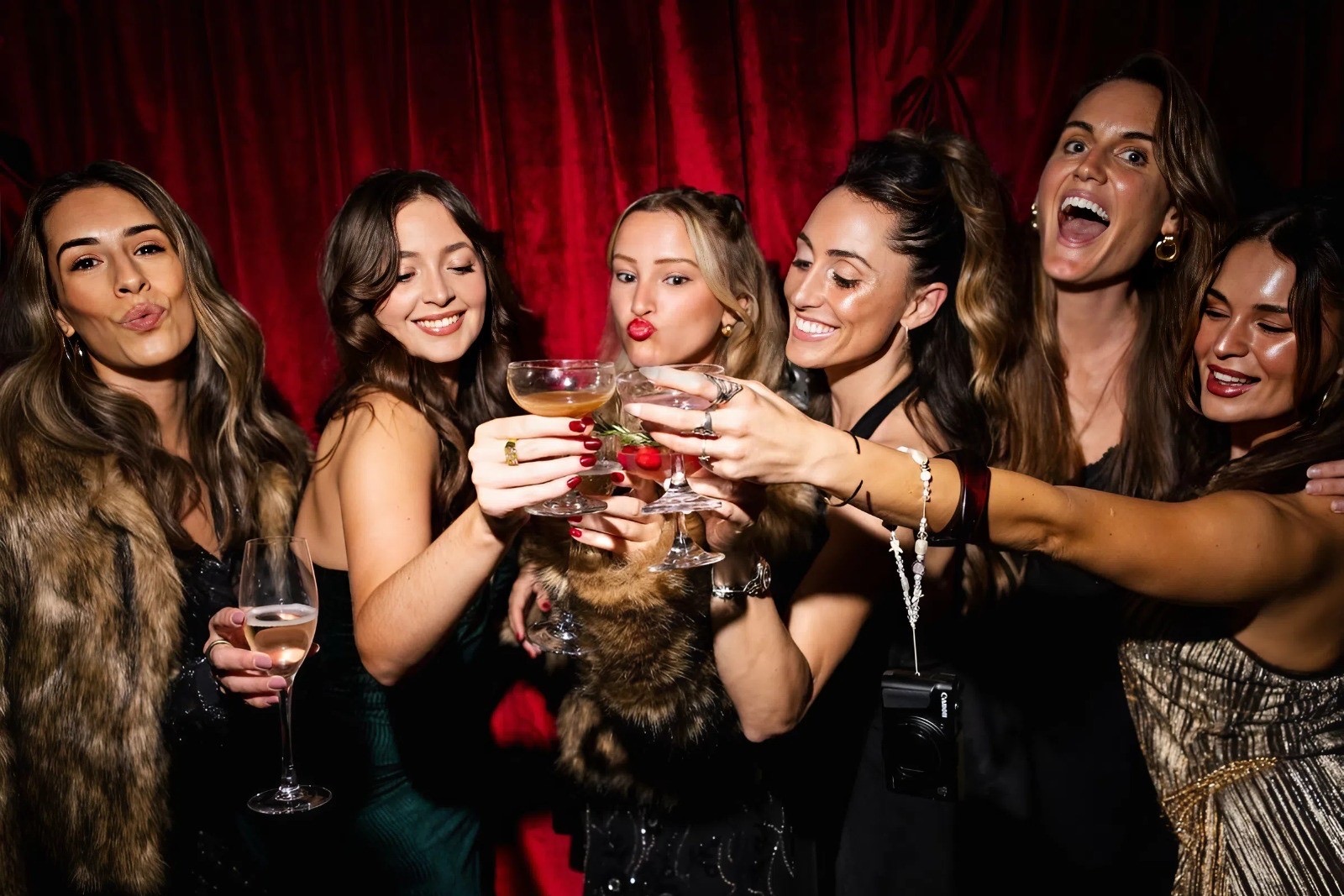Friends toasting at a Saucy event